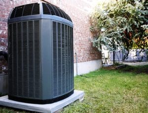 An air conditioning unit in a backyard.