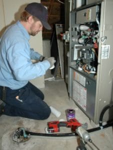Technician repairing a furnace