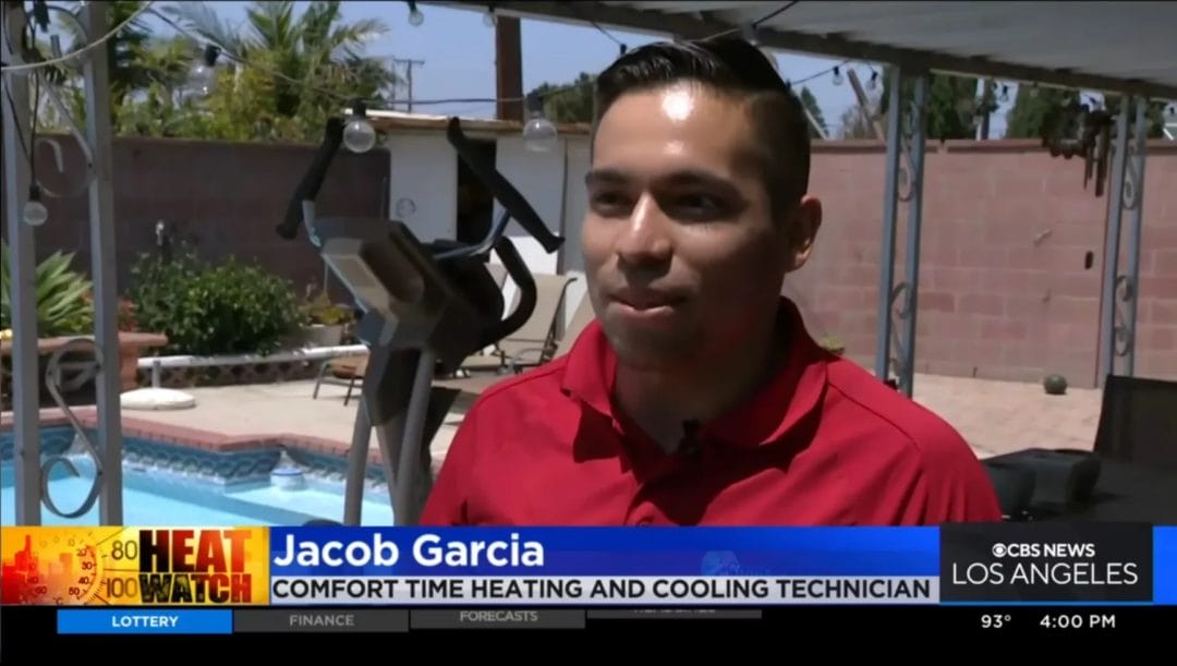 A man being interviewed outdoors with a caption identifying him as a heating and cooling technician.